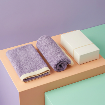 Lavender cream towel duo on peach podium