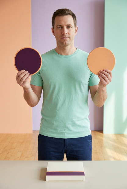 Adult American-looking male model holding the same two exercise slider discs