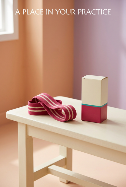 A Place in Your Practice: loosely arranged raspberry exercise loop beside matching carton
