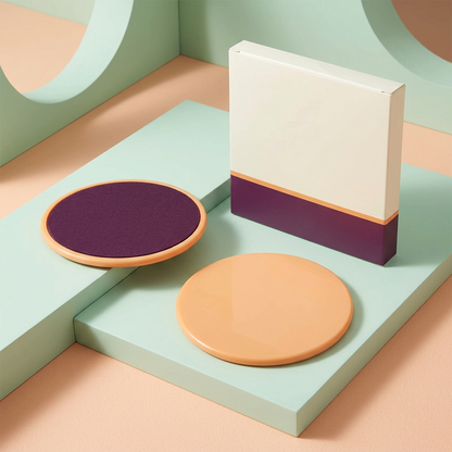 Two exercise slider discs showing plum textile face and apricot reverse with matching blank carton