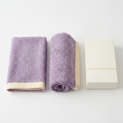 Two lavender cream towels on white background